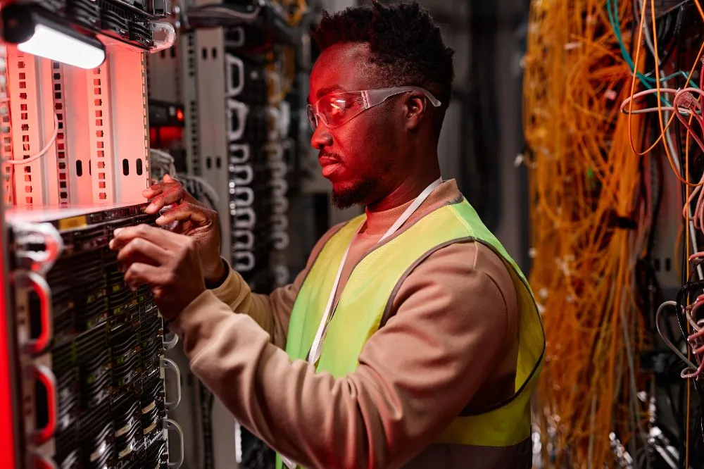 network technician inspecting servers in a data center