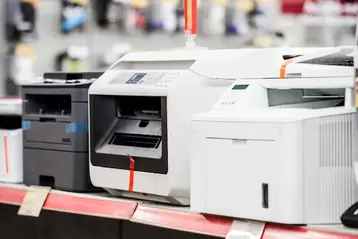 Multiple laser printers on display in a computer electronics store
