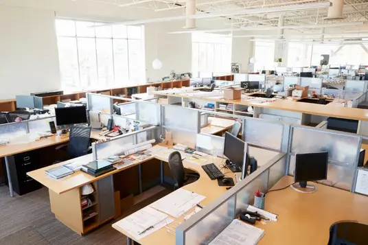 Partitioned computer workstations arranged in a modern open-plan office